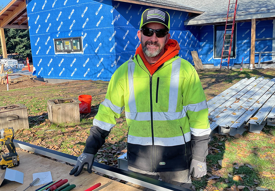 Former Blanchet Farm Resident Aaron Conard works on new dormitory