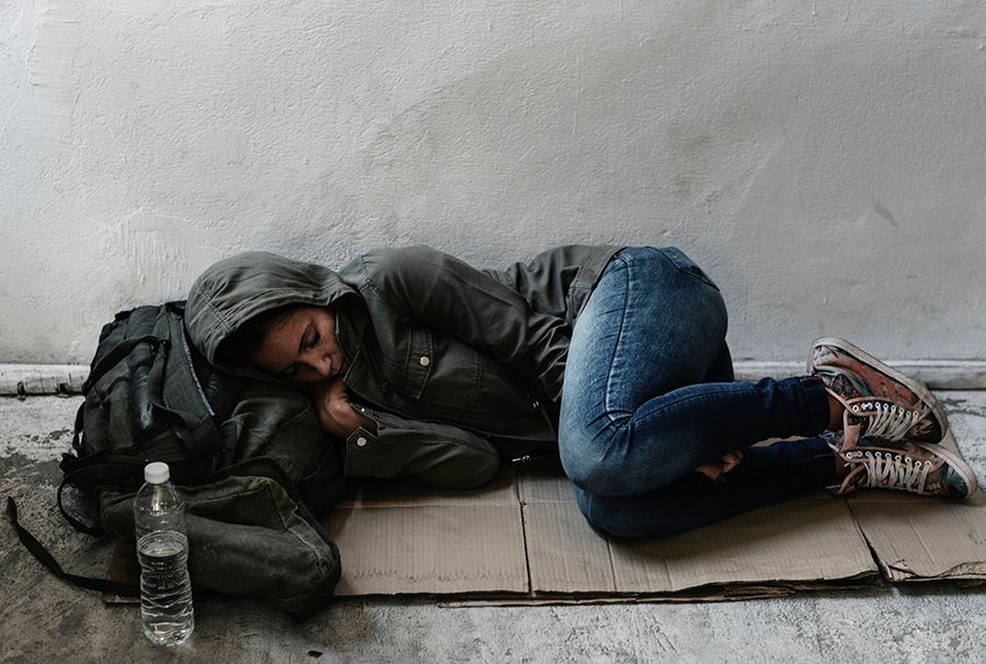 Homeless woman lay on ground