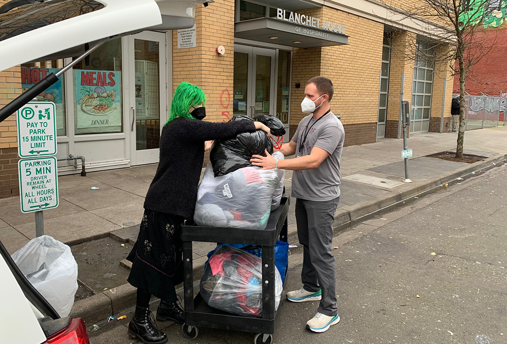 Donor drops off used clothing at Blanchet House.